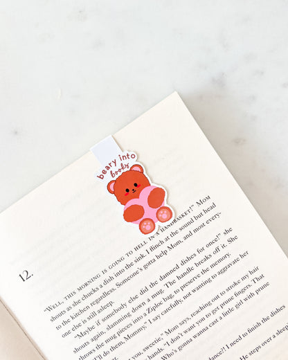 Book with a teddy bear bookmark on a white background